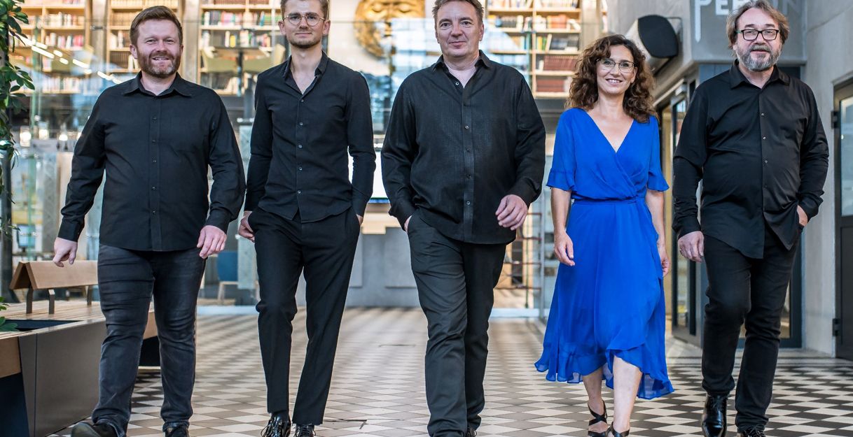 Fünf Musizierende gehen auf die Kamera zu